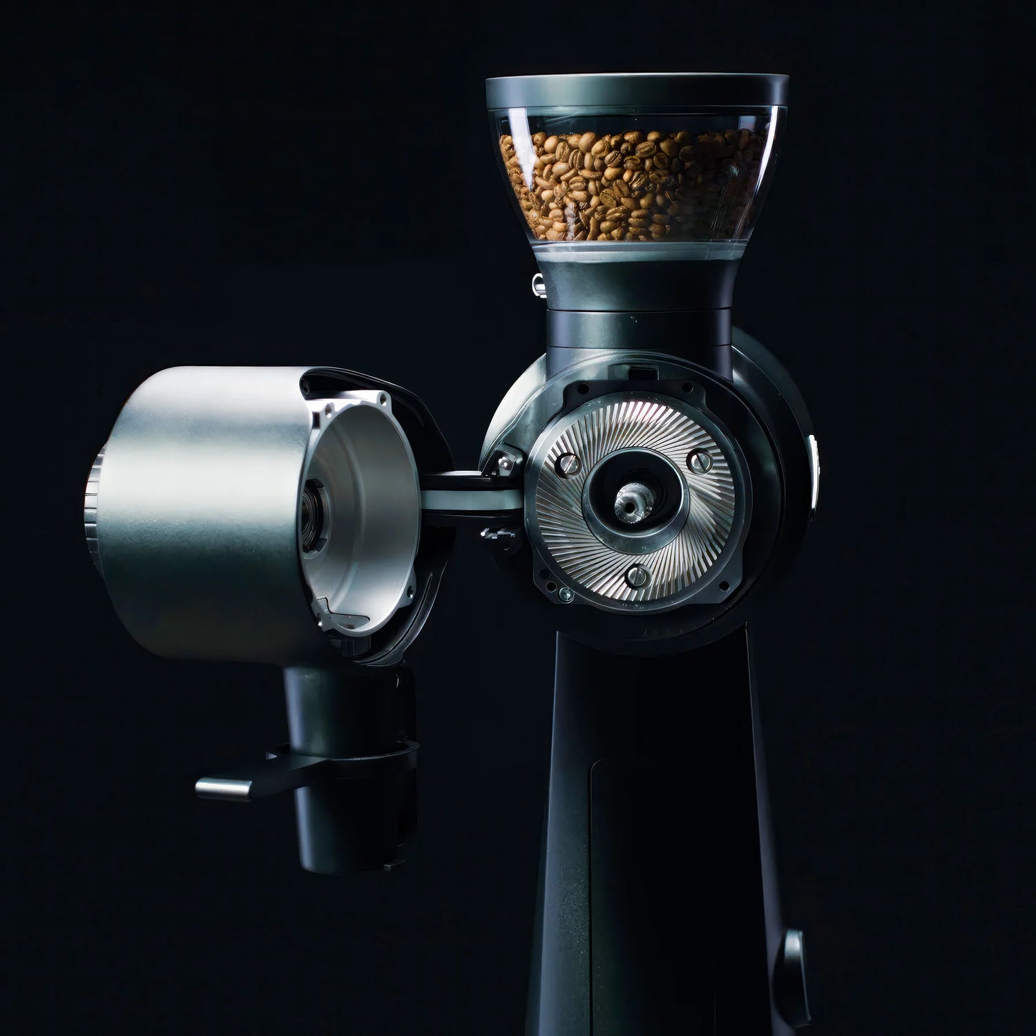 Coffee grinder with coffee beans on a black background